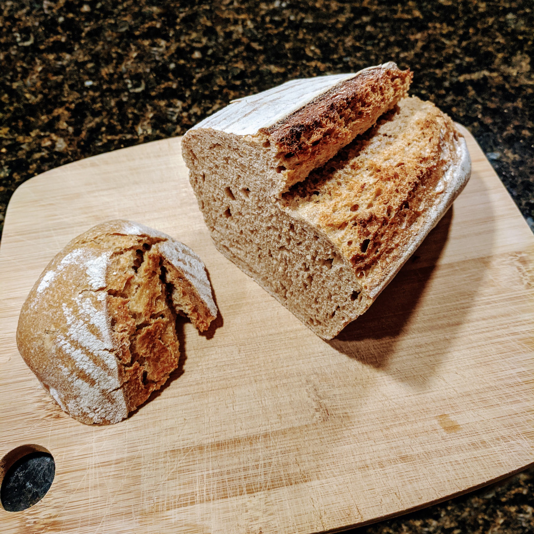 Half a loaf of sourdough bread on a cutting board