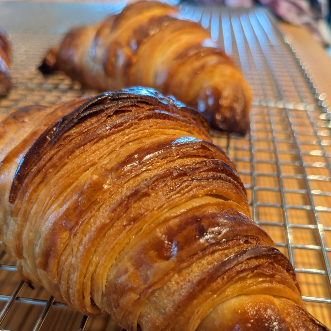 Close up view of a croissant showing off the lamination